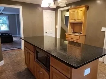 a kitchen with stainless steel appliances granite countertop a sink a stove and a refrigerator