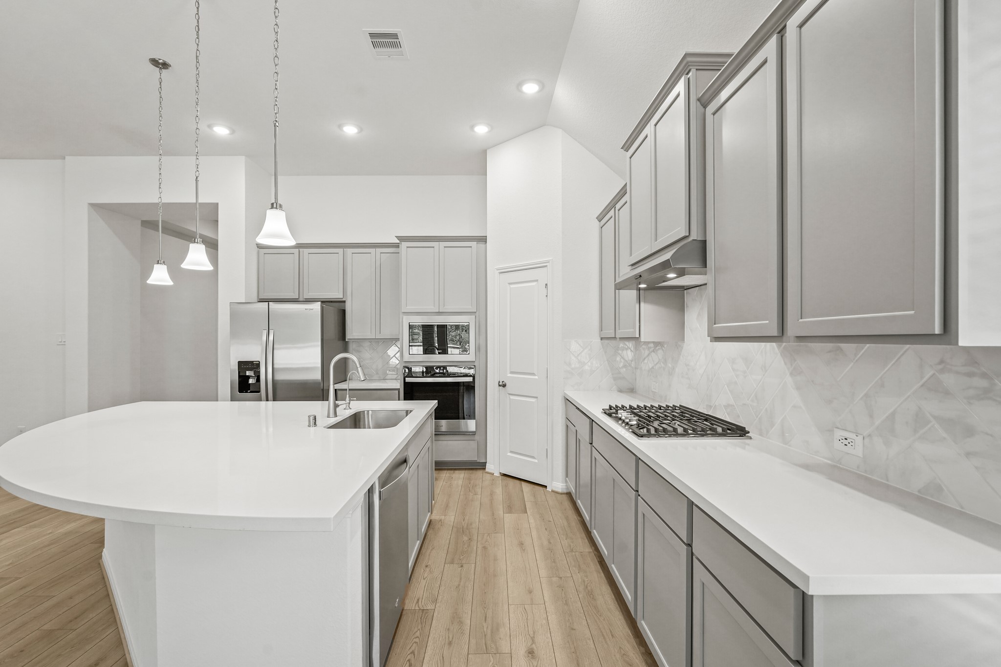 1420 Florecer Lane Magnolia, TX 77354 - Photo 12 of 22 a kitchen with stainless steel appliances a refrigerator a stove a sink and white cabinets