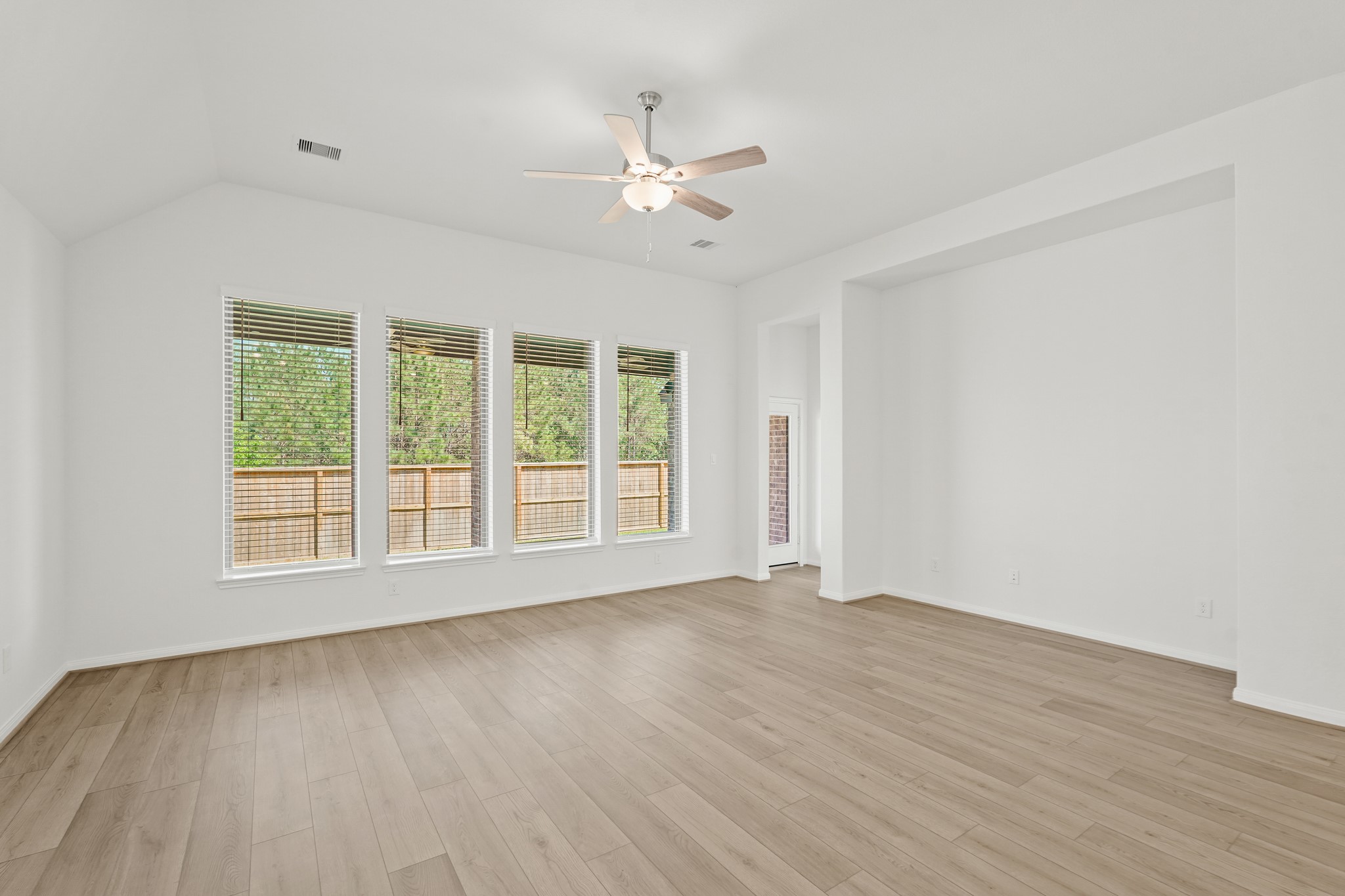 1420 Florecer Lane Magnolia, TX 77354 - Photo 14 of 22 a view of an empty room with wooden floor and a window
