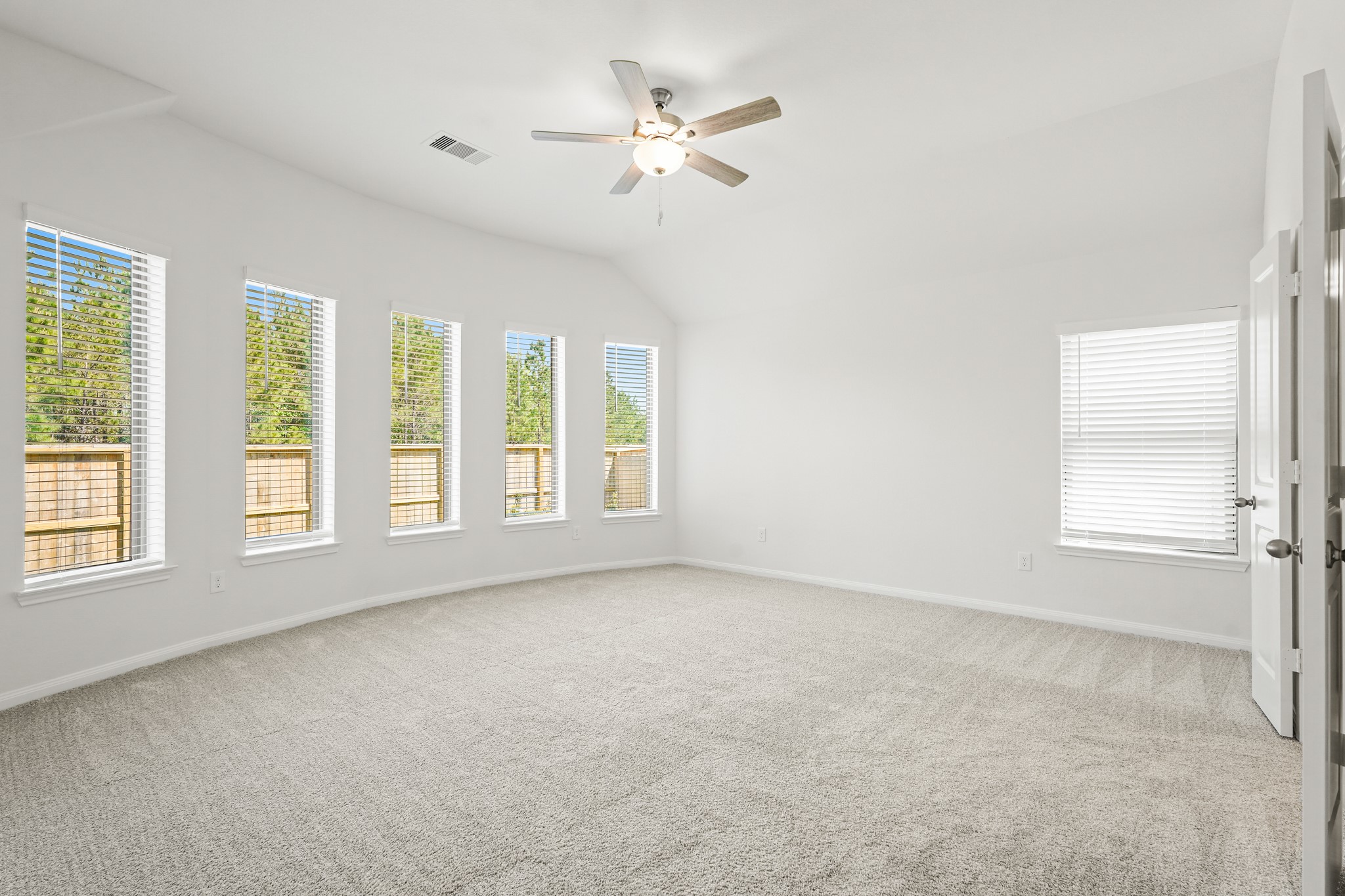 1420 Florecer Lane Magnolia, TX 77354 - Photo 16 of 22 an empty room with chandelier fan and windows