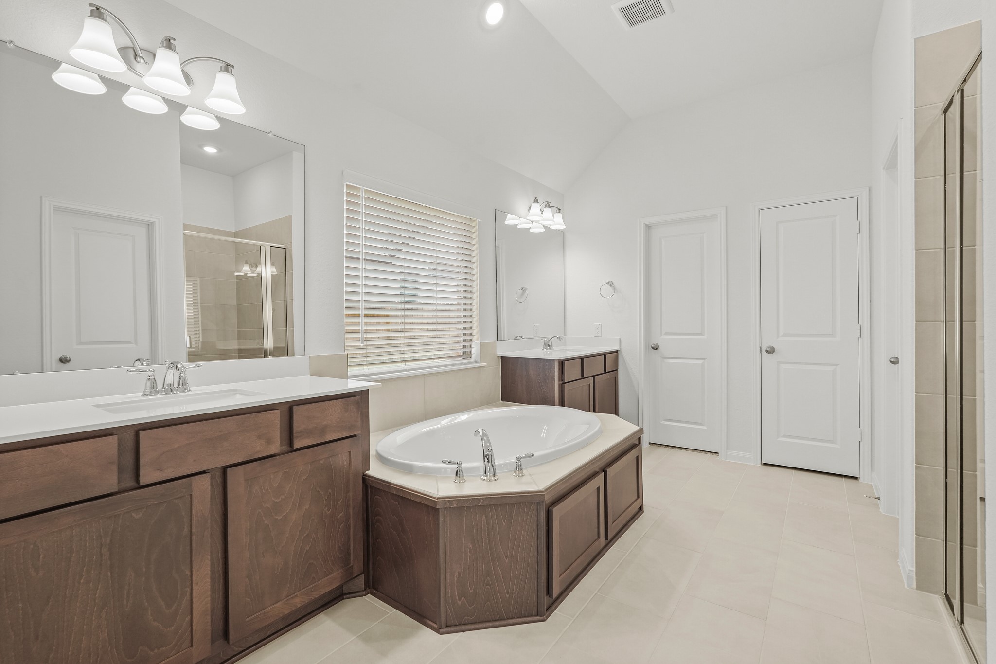 1420 Florecer Lane Magnolia, TX 77354 - Photo 18 of 22 a bathroom with a tub a double vanity sink and a mirror