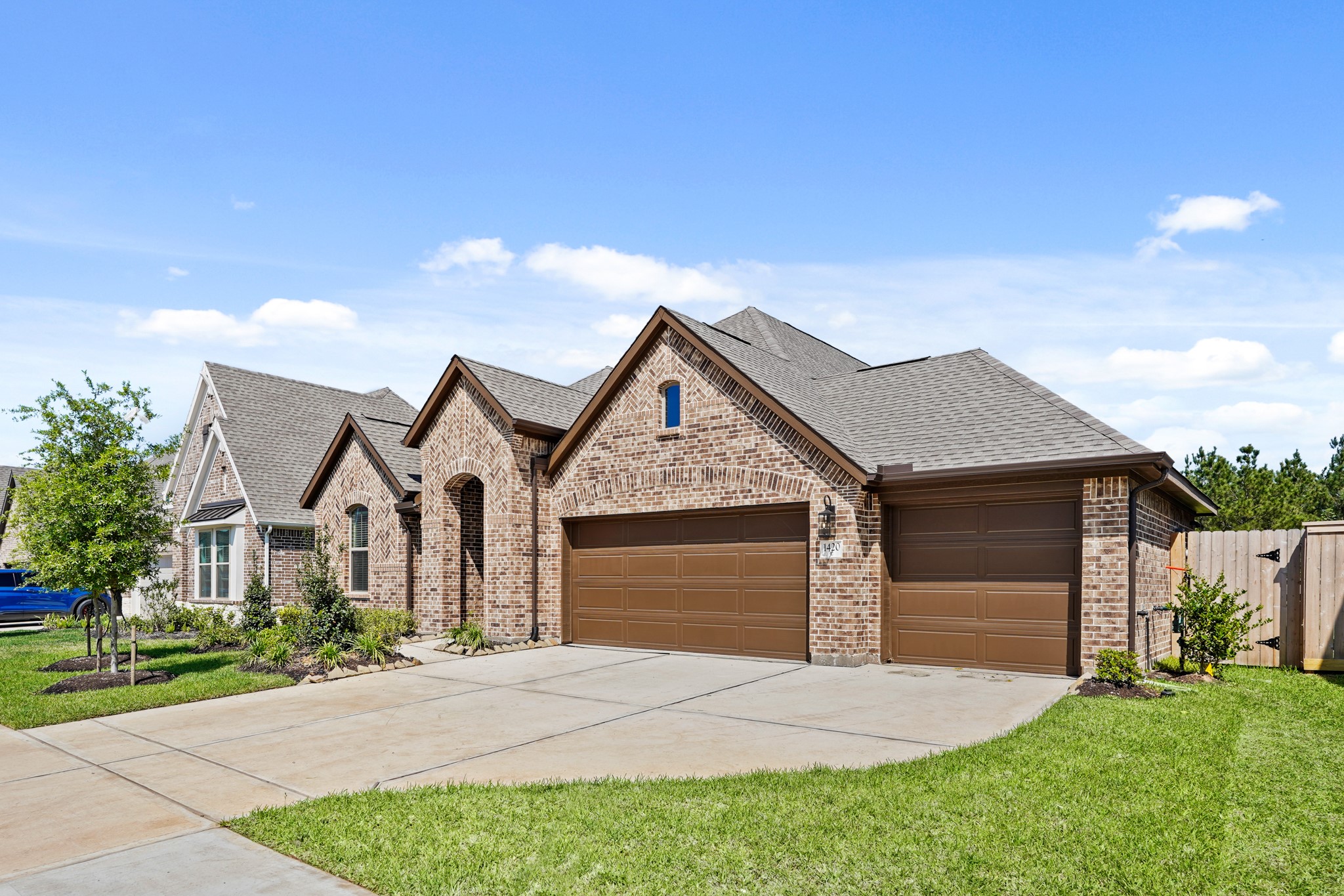 1420 Florecer Lane Magnolia, TX 77354 - Photo 2 of 22 a front view of a house with a yard and garage