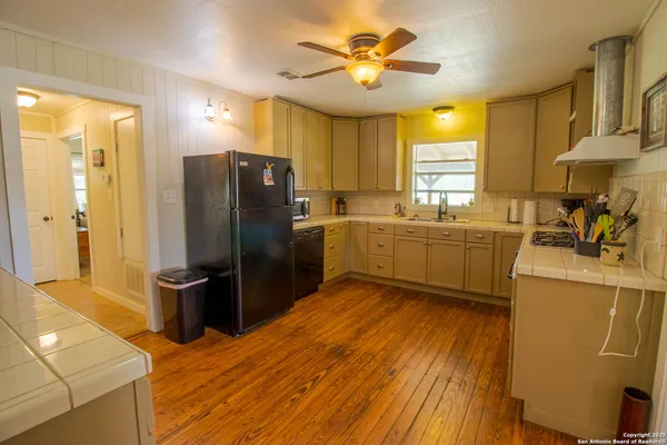 a kitchen with stainless steel appliances a stove a refrigerator and a sink