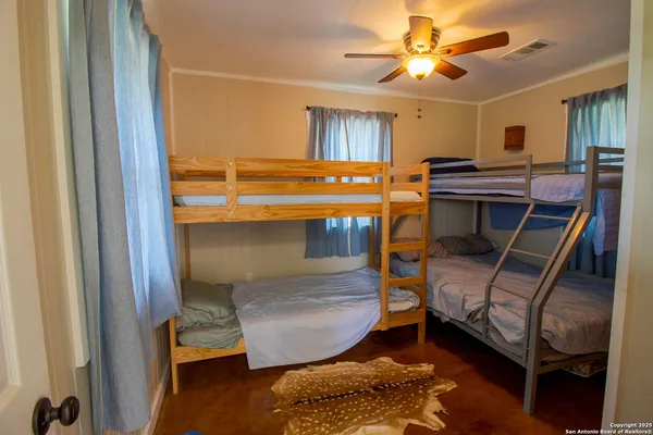 a bedroom with bunk beds and a window