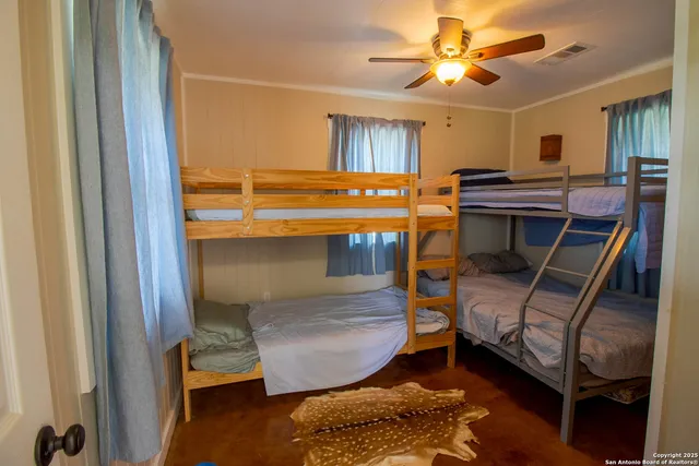 a bedroom with bunk beds and a window