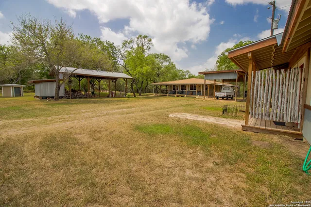 a view of a house with a yard and sitting area