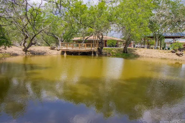 a view of residential houses with swimming pool and lake view