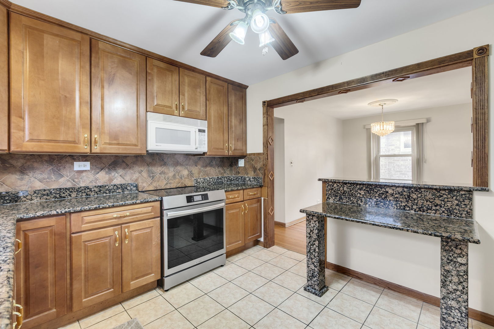3253 North Austin Avenue Chicago, IL 60634 - Photo 5 of 16 a kitchen with stainless steel appliances granite countertop a stove and a sink