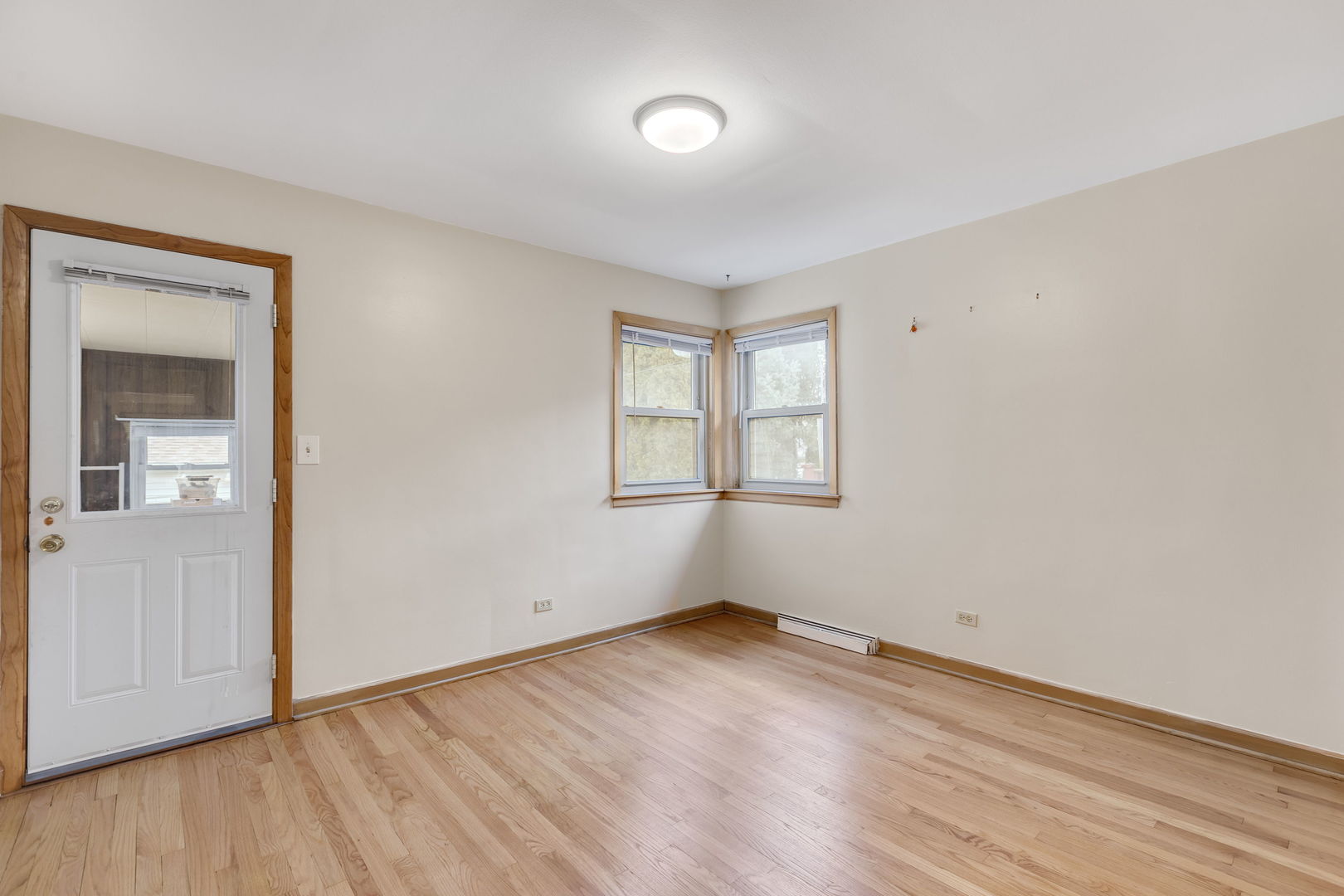 3253 North Austin Avenue Chicago, IL 60634 - Photo 7 of 16 an empty room with wooden floor and windows