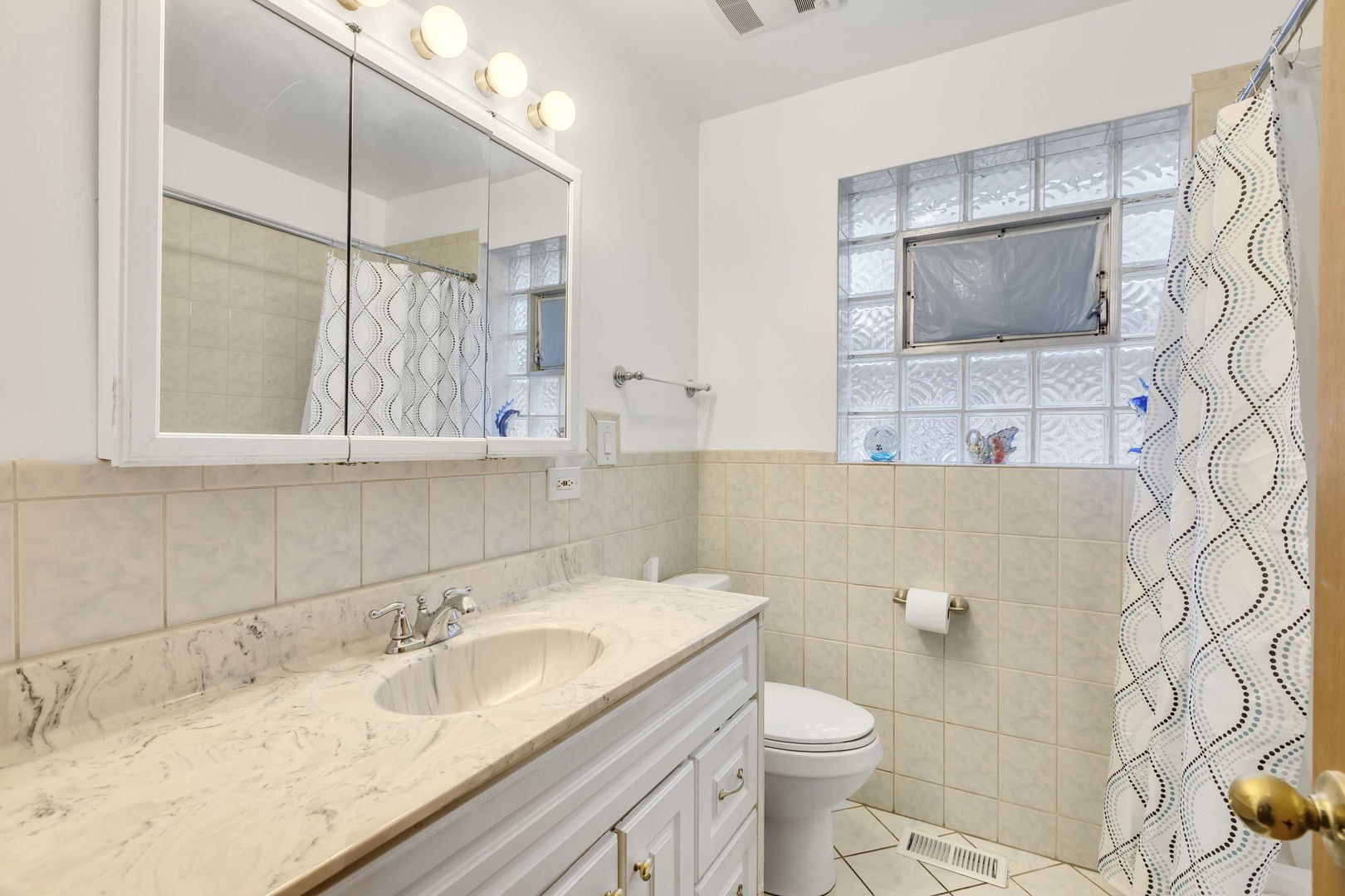 3253 North Austin Avenue Chicago, IL 60634 - Photo 10 of 16 a bathroom with a granite countertop sink toilet and mirror