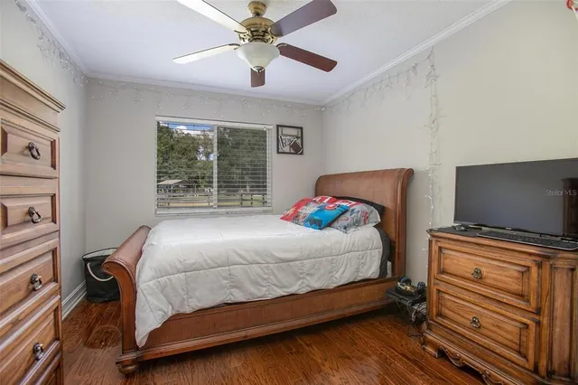 a bedroom with a bed and a flat tv screen