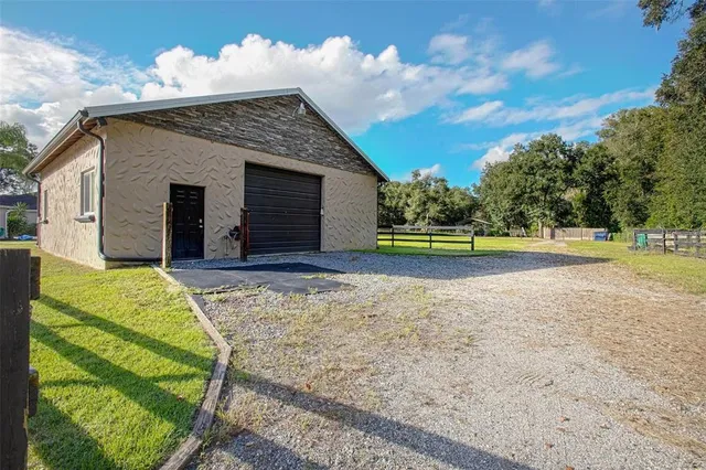 a view of a house with a yard and garage