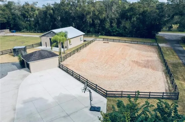 an outdoor space with swimming pool and furniture