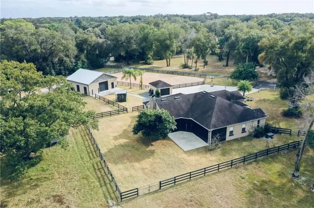 a view of a house with pool and a yard