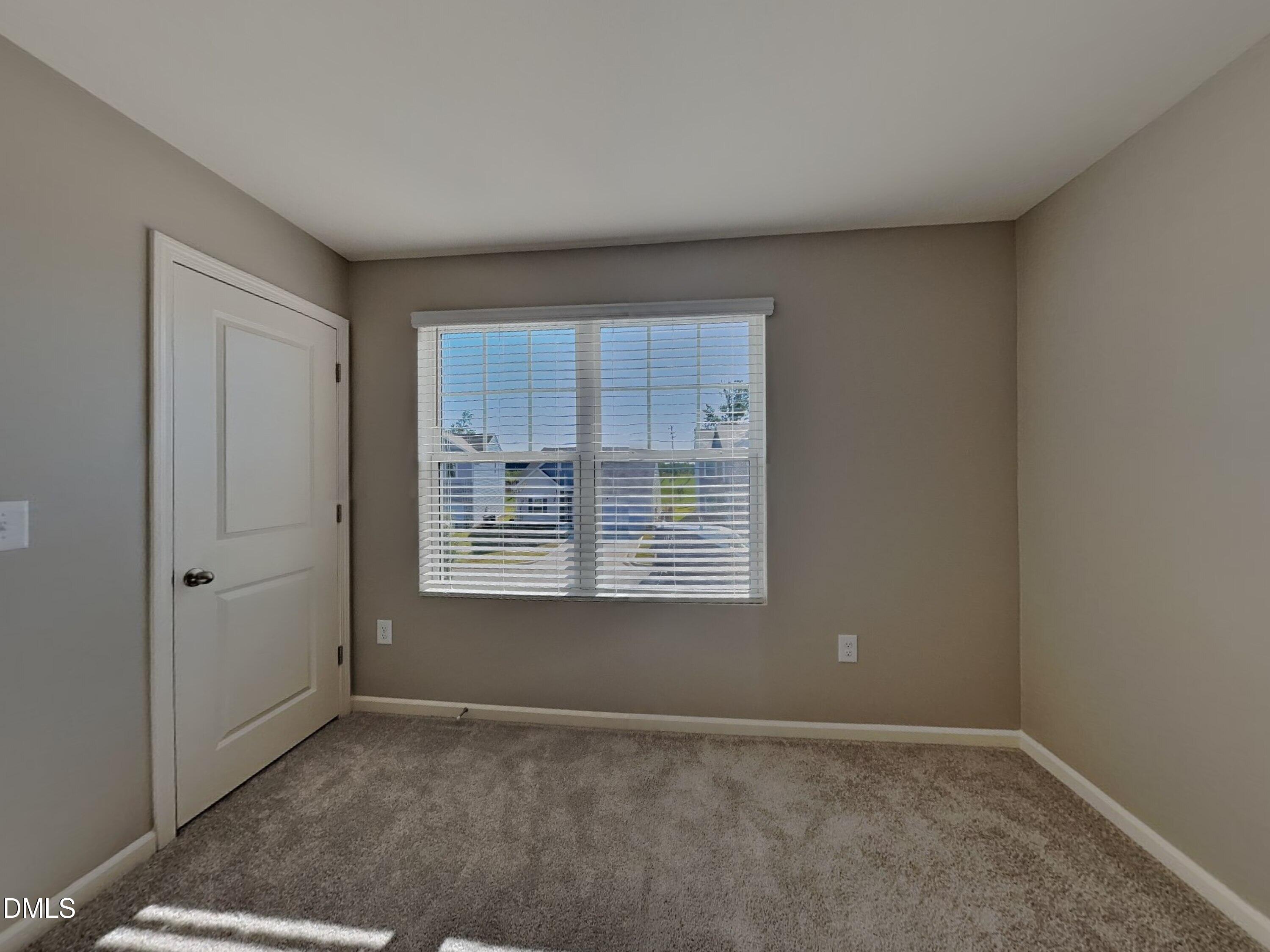 152 Glad Stone Loop Clayton, NC 27520 - Photo 12 of 20 a view of an empty room with a window