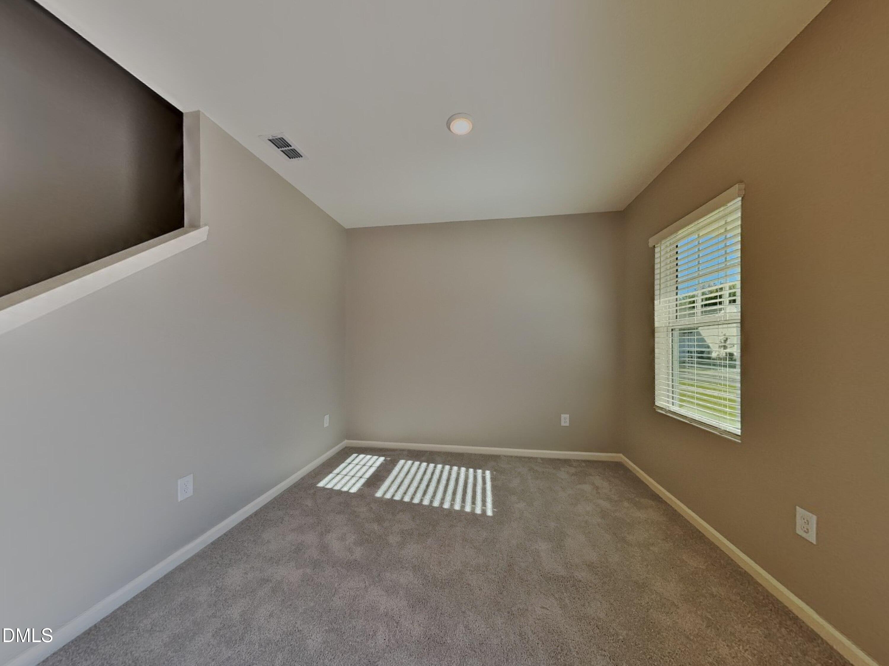 152 Glad Stone Loop Clayton, NC 27520 - Photo 17 of 20 a view of an empty room with a window