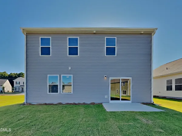 a view of a house with a backyard