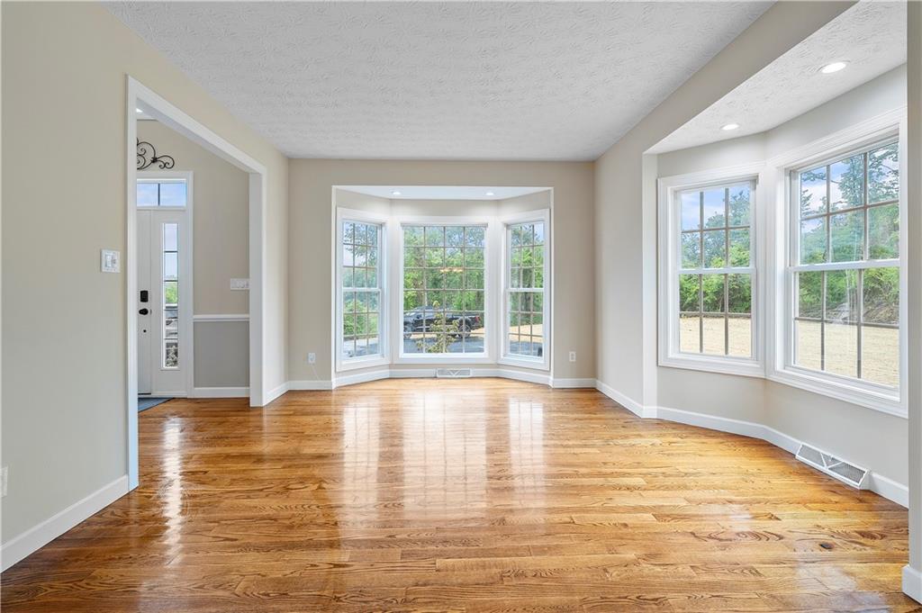 192 Baldwin Road Carnegie, PA 15106 - Photo 24 of 50 a view of an empty room with wooden floor and a window