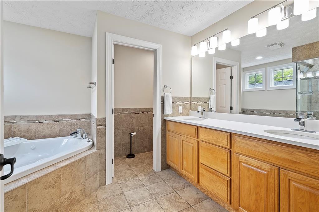 192 Baldwin Road Carnegie, PA 15106 - Photo 29 of 50 a spacious bathroom with a tub sink and mirror