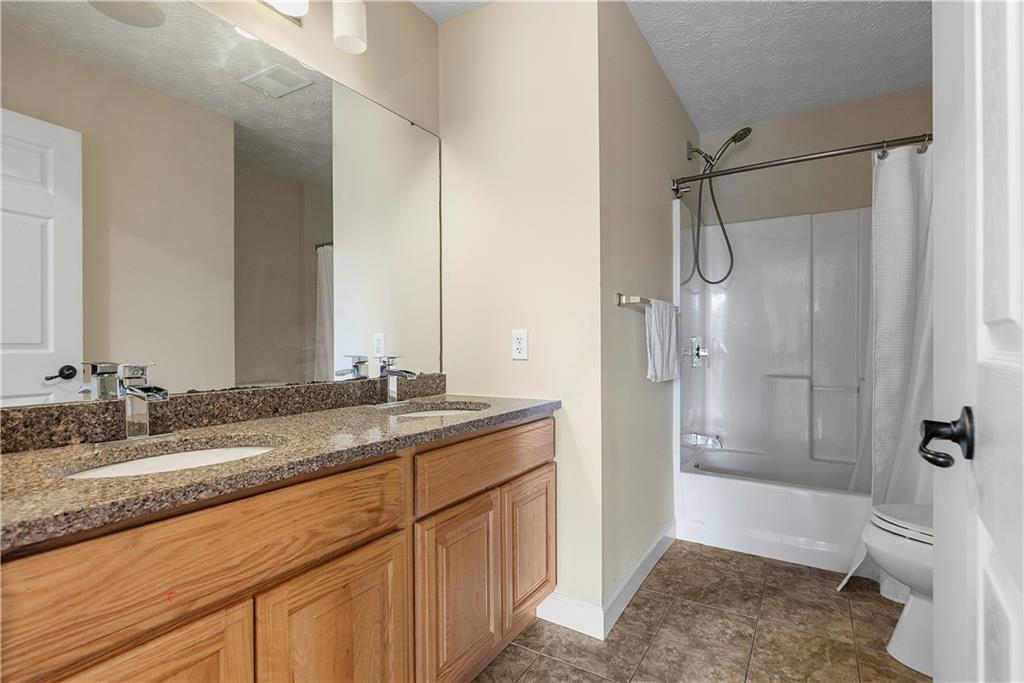 192 Baldwin Road Carnegie, PA 15106 - Photo 34 of 50 a bathroom with a granite countertop sink mirror toilet and bathtub