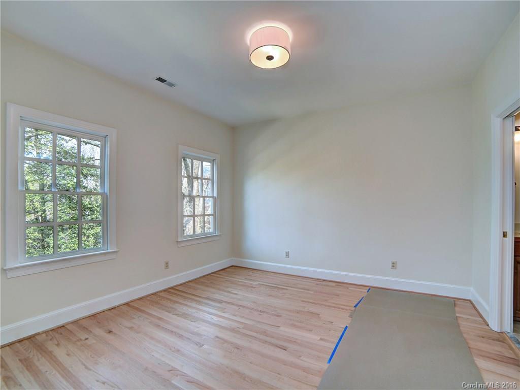 2101 Scotland Ridge Road Charlotte, NC 28211 - Photo 16 of 24 an empty room with wooden floor and windows