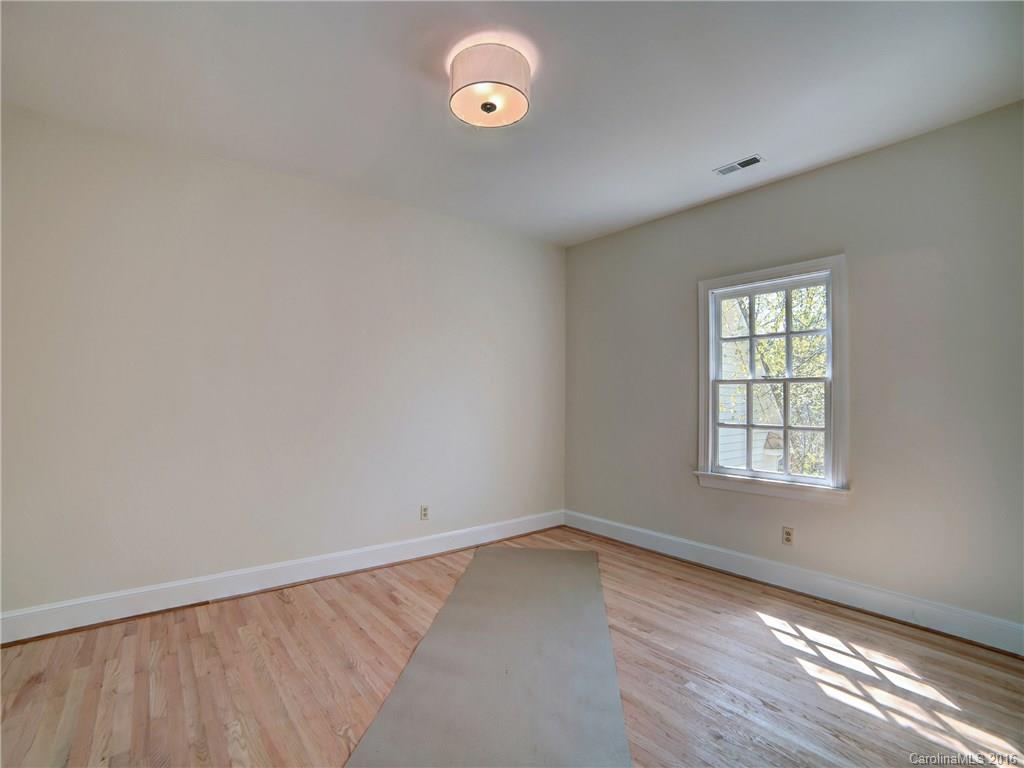 2101 Scotland Ridge Road Charlotte, NC 28211 - Photo 18 of 24 an empty room with wooden floor and windows