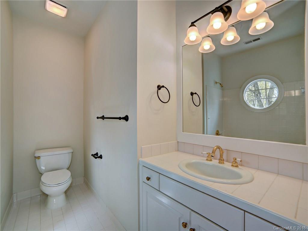 2101 Scotland Ridge Road Charlotte, NC 28211 - Photo 19 of 24 a bathroom with a toilet sink and a mirror