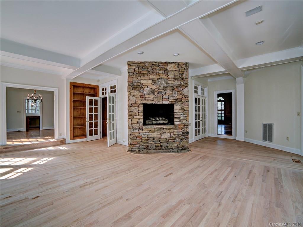 2101 Scotland Ridge Road Charlotte, NC 28211 - Photo 8 of 24 a view of an empty room with wooden floor fireplace and a window