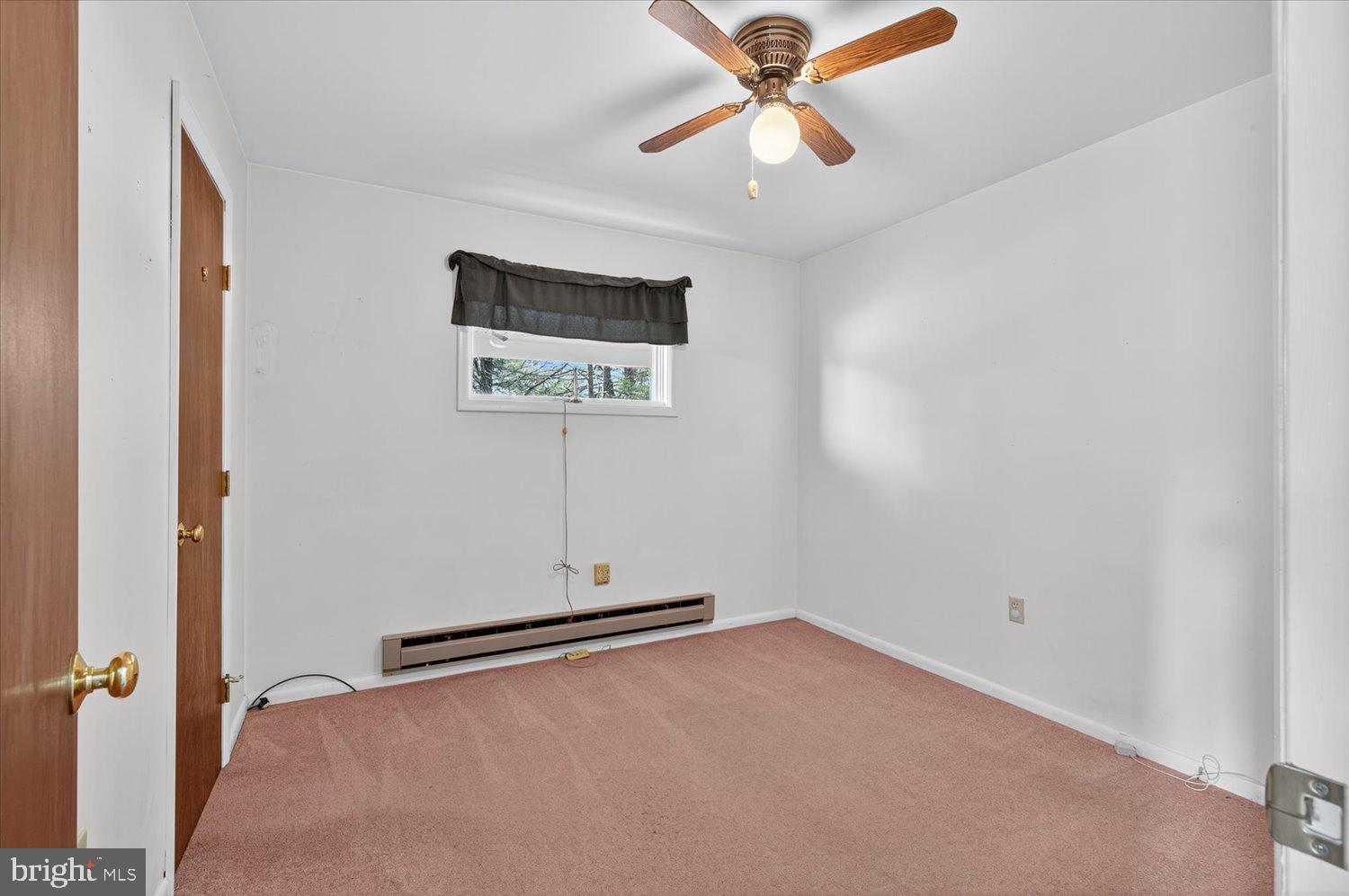 175 Eastbrook Road Smoketown, PA 17576 - Photo 11 of 24 an empty room with a ceiling fan and a window