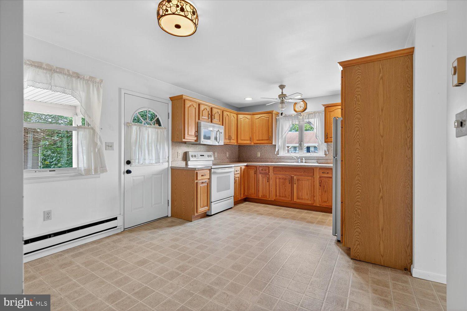 175 Eastbrook Road Smoketown, PA 17576 - Photo 8 of 24 a kitchen with a refrigerator a stove a microwave and a window