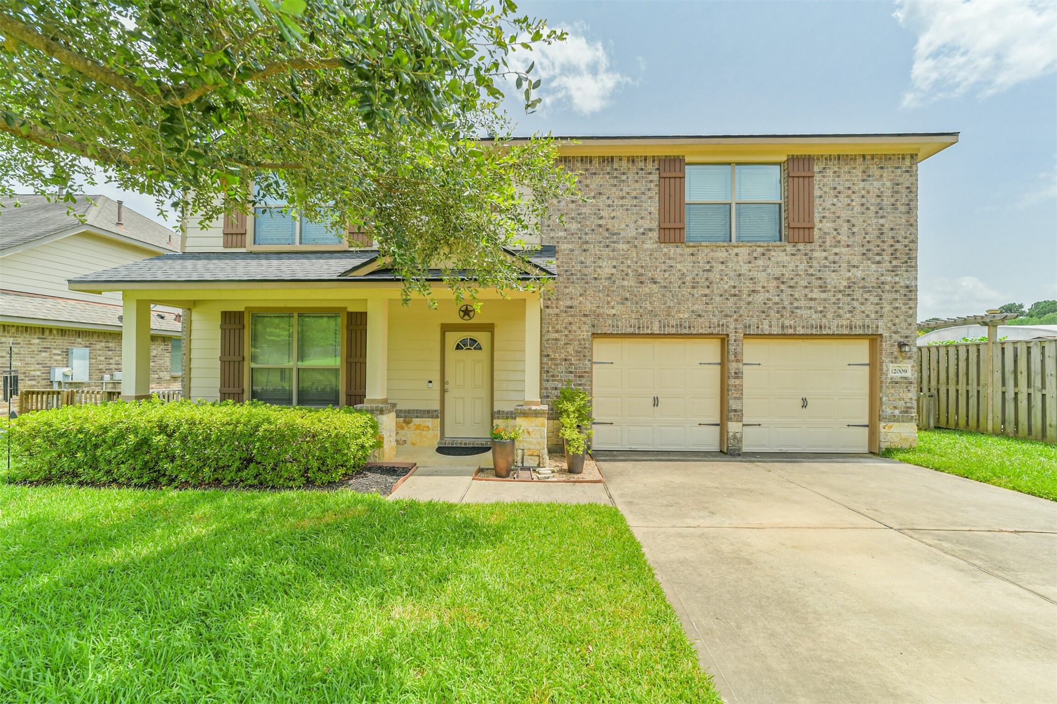 12009 La Salle River Road Conroe, TX 77304 - Photo 2 of 50 a front view of a house with a yard and garage