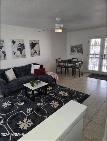 a living room with furniture a rug and a table