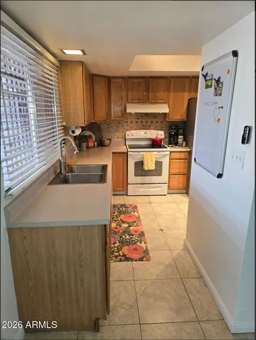 a kitchen with stainless steel appliances granite countertop a refrigerator and a stove