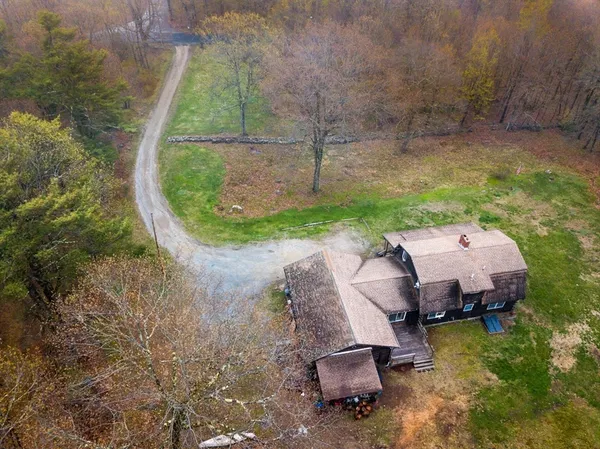 a aerial view of a house with backyard