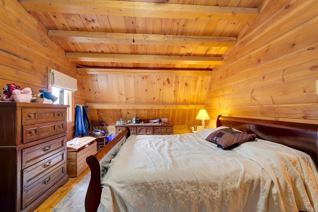 207 West Princeton Road Westminster, MA 01473 - Photo 16 of 36 a bedroom with a bed and wooden cabinets