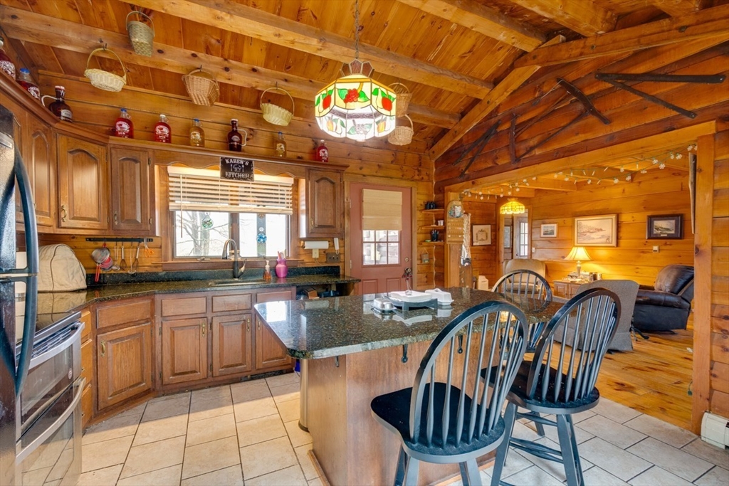 207 West Princeton Road Westminster, MA 01473 - Photo 6 of 36 a view of a kitchen with granite countertop lots of counter top space a dining table and chairs