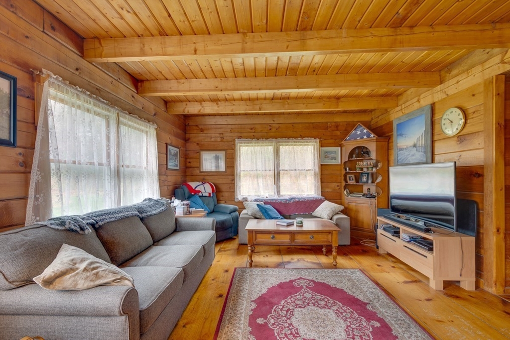 207 West Princeton Road Westminster, MA 01473 - Photo 9 of 36 a living room with furniture a flat screen tv and a rug