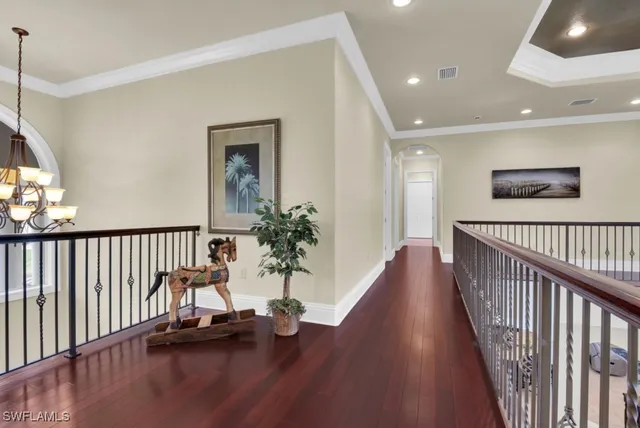 a bedroom with a large bed and windows