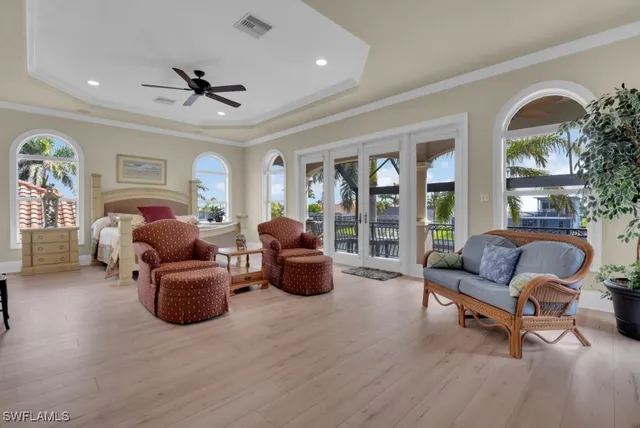 a bedroom with 2 bed and a chandelier