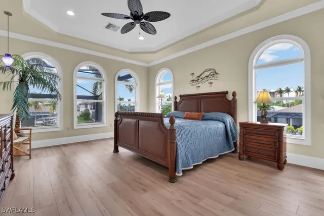 a view of a house with a yard and potted plants