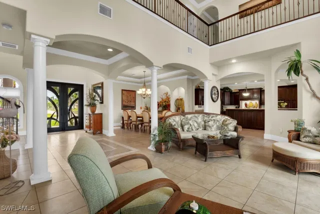 a view of a dining room with furniture and a chandelier