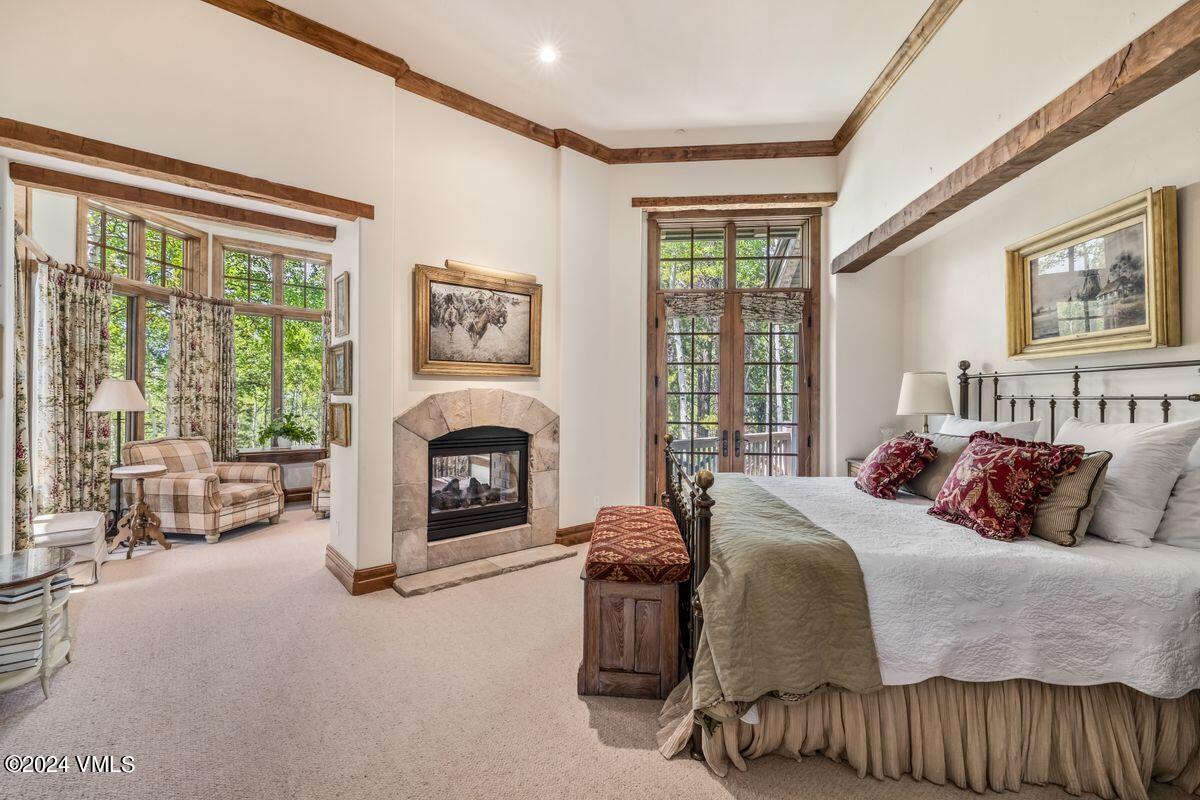 2286 Daybreak Ridge Road Avon, CO 81620 - Photo 12 of 33 a bedroom with a bed and a fireplace