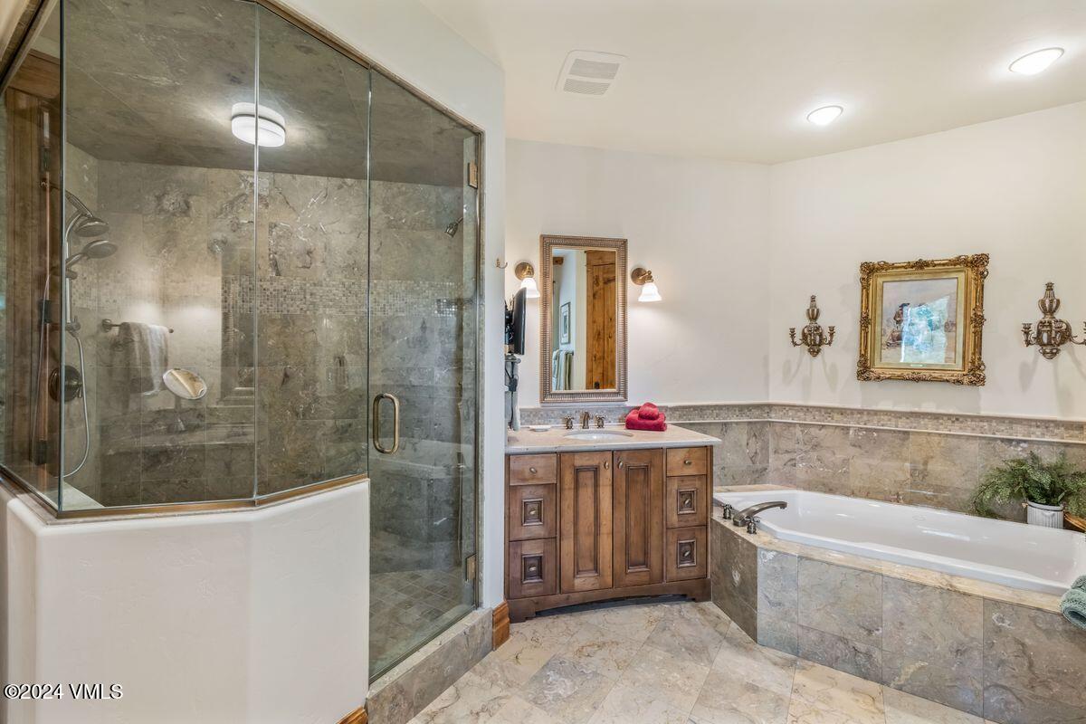 2286 Daybreak Ridge Road Avon, CO 81620 - Photo 14 of 33 a bathroom with a bathtub and a shower