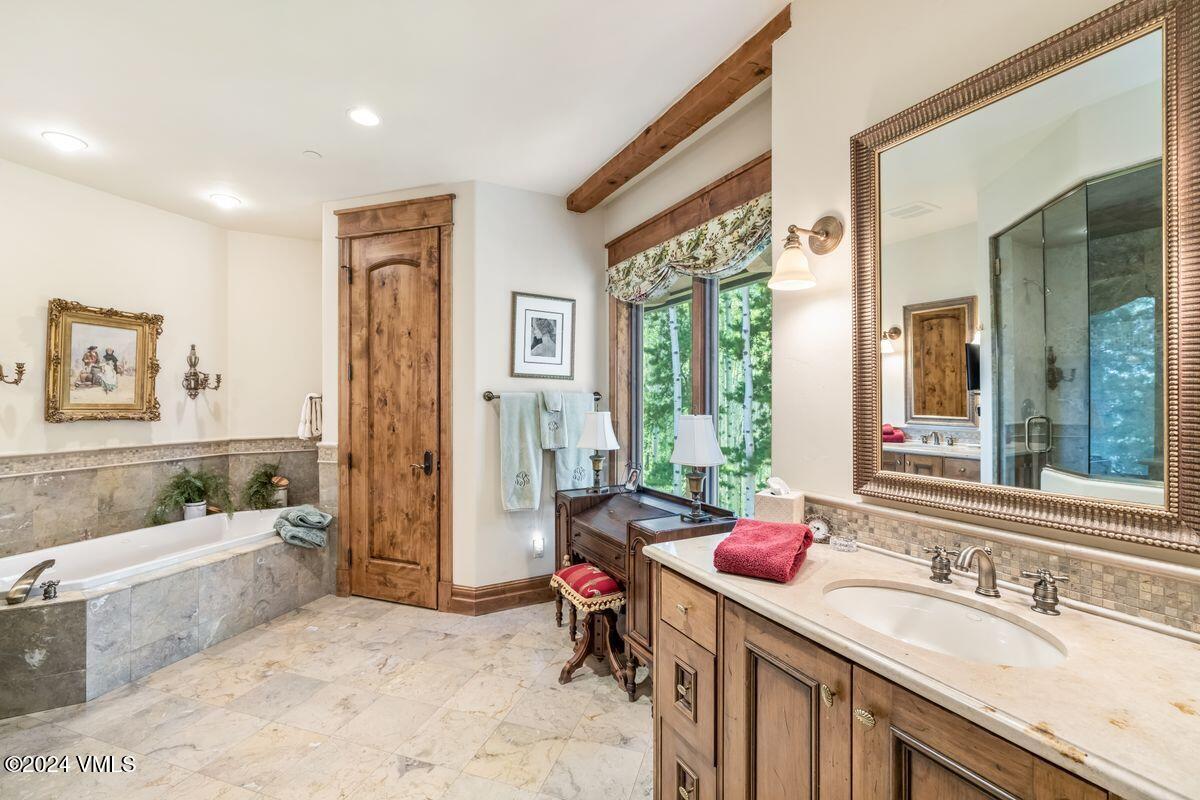 2286 Daybreak Ridge Road Avon, CO 81620 - Photo 15 of 33 a spacious bathroom with a tub a sink and mirror