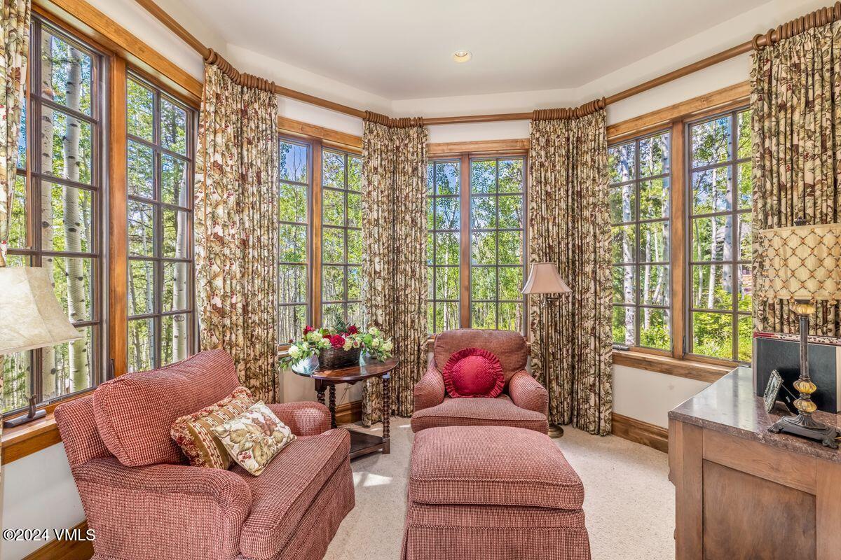 2286 Daybreak Ridge Road Avon, CO 81620 - Photo 26 of 33 a living room with furniture and floor to ceiling windows