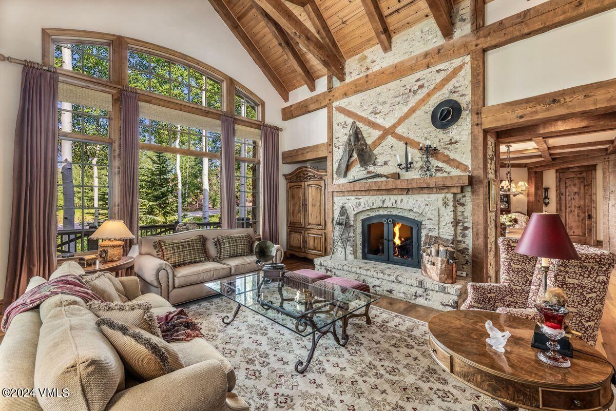 2286 Daybreak Ridge Road Avon, CO 81620 - Photo 6 of 33 a living room with furniture a fireplace and a floor to ceiling windows