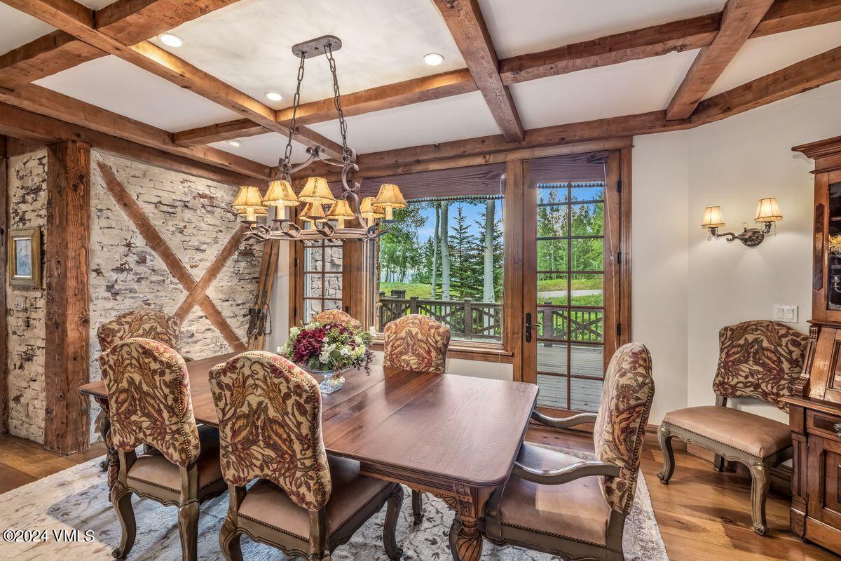 2286 Daybreak Ridge Road Avon, CO 81620 - Photo 8 of 33 a dining room with furniture a chandelier and wooden floor