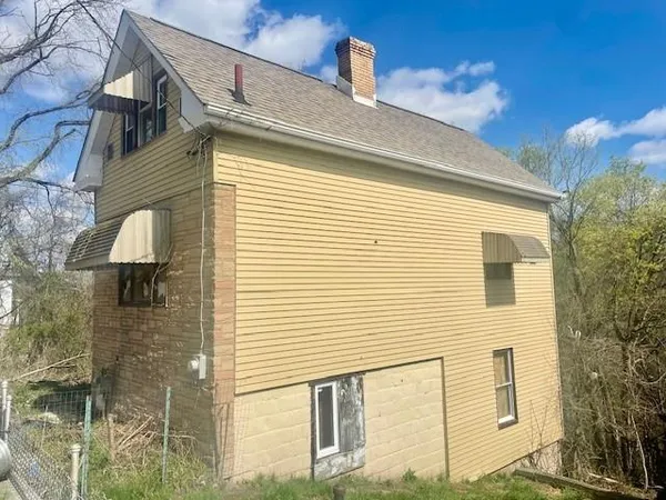 a view of a house with a brick wall