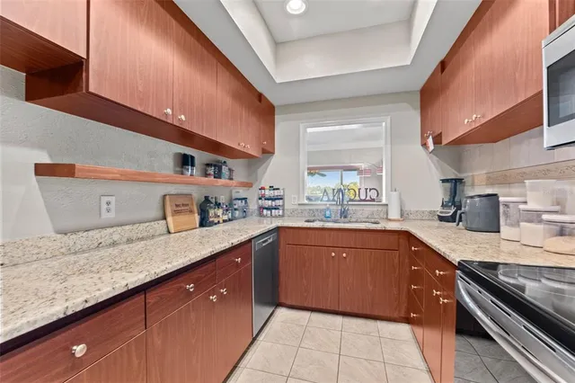 a kitchen with stainless steel appliances granite countertop a sink and stove