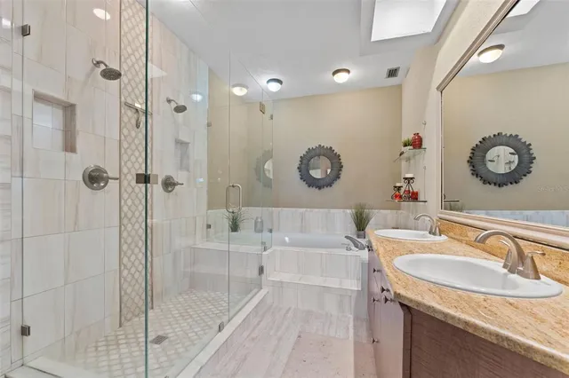 a bathroom with a granite countertop sink mirror and shower